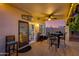 Cozy covered patio with ceiling fan, bistro lighting, and outdoor dining furniture at 7053 S Heather Dr, Tempe, AZ 85283