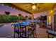 Covered patio with bistro lighting, table, and chairs overlooking a sparkling pool at 7053 S Heather Dr, Tempe, AZ 85283