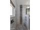 Modern tiled shower with rainfall showerhead and decorative stone flooring at 7053 S Heather Dr, Tempe, AZ 85283
