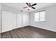 Bright bedroom featuring wood floors, a ceiling fan, and a closet with sliding doors at 706 E Washington St # 204, Phoenix, AZ 85034