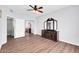 Bedroom boasts wood floors, a ceiling fan, a mirrored closet, and a dresser at 706 E Washington St # 204, Phoenix, AZ 85034