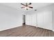 This bedroom features wood flooring, ceiling fan, and double door closets at 706 E Washington St # 204, Phoenix, AZ 85034