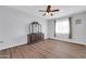 Spacious bedroom with a ceiling fan, wood floors, and a wooden dresser at 706 E Washington St # 204, Phoenix, AZ 85034