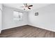 Bright bedroom featuring wood floors, a ceiling fan, and a window at 706 E Washington St # 204, Phoenix, AZ 85034