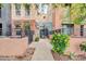Charming exterior showcasing a walkway adorned with lush greenery and flowering plants at 706 E Washington St # 204, Phoenix, AZ 85034