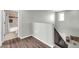 Open landing with views of the updated bathroom and staircase to upper level at 706 E Washington St # 204, Phoenix, AZ 85034