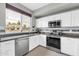 Bright kitchen features stainless steel appliances, granite counters, and white cabinetry at 706 E Washington St # 204, Phoenix, AZ 85034