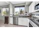 Kitchen view showcases stainless steel appliances and a window with neighborhood views at 706 E Washington St # 204, Phoenix, AZ 85034