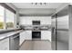 Modern kitchen with stainless steel appliances, white cabinets, and a bright window at 706 E Washington St # 204, Phoenix, AZ 85034