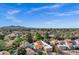 Captivating aerial view showcasing lush landscaping, terra-cotta roofs, and mature palms against a mountain backdrop at 7168 N Via De Amigos --, Scottsdale, AZ 85258