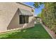 Lush backyard with artificial turf, offering a low-maintenance and aesthetically pleasing outdoor space with shade from trees at 7168 N Via De Amigos --, Scottsdale, AZ 85258