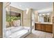 Bright bathroom with soaking tub, double vanity, and beautiful window view at 7168 N Via De Amigos --, Scottsdale, AZ 85258