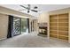 Bedroom with ceiling fan, fireplace, custom shelving and patio access at 7168 N Via De Amigos --, Scottsdale, AZ 85258