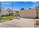 Striking home exterior featuring a spacious three-car garage, vibrant landscaping, and mature palm trees at 7168 N Via De Amigos --, Scottsdale, AZ 85258