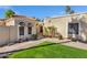 Inviting home exterior featuring a well-manicured lawn, desert landscaping, and a charming covered entrance at 7168 N Via De Amigos --, Scottsdale, AZ 85258