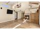 Open living area with high ceilings, stone fireplace, and tile flooring; TV mounted on the wall at 7168 N Via De Amigos --, Scottsdale, AZ 85258