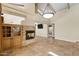 Open living room featuring a stone fireplace, built-in cabinets, and tile flooring at 7168 N Via De Amigos --, Scottsdale, AZ 85258