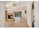 Open-concept living room with a stone fireplace, tile flooring, and sliding glass doors to the backyard at 7168 N Via De Amigos --, Scottsdale, AZ 85258