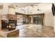 Inviting living room with a cozy stone fireplace, tile floors, and sliding glass doors leading to the backyard at 7168 N Via De Amigos --, Scottsdale, AZ 85258