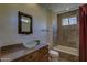 Stylish bathroom featuring vanity with vessel sink, shower and tub combination at 7322 E High Point Dr, Scottsdale, AZ 85266