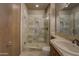 Stylish bathroom featuring a glass door shower and vanity with sink at 7322 E High Point Dr, Scottsdale, AZ 85266