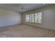 A spacious bedroom with large windows and a neutral color scheme at 7322 E High Point Dr, Scottsdale, AZ 85266