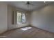 Bright bedroom featuring a ceiling fan and a window with mountain views at 7322 E High Point Dr, Scottsdale, AZ 85266