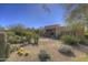 Desert home exterior with natural desert landscaping and a charming front yard area at 7322 E High Point Dr, Scottsdale, AZ 85266
