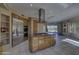 Spacious kitchen featuring wood cabinets, granite countertops, stainless steel appliances, and a center island cooktop at 7322 E High Point Dr, Scottsdale, AZ 85266