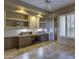 Open living room featuring built-in shelves, tile floors, and a ceiling fan at 7322 E High Point Dr, Scottsdale, AZ 85266