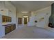 Spacious living room featuring a fireplace, wet bar, and access to the front entrance at 7322 E High Point Dr, Scottsdale, AZ 85266