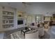 Chic living room with built-in shelving, a modern entertainment center, and stylish furniture at 7322 E High Point Dr, Scottsdale, AZ 85266