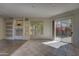 Bright living room with built-in shelving and sliding doors leading to a beautiful outdoor view at 7322 E High Point Dr, Scottsdale, AZ 85266