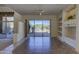 Open living room with built-in shelving and a seamless transition to an outdoor patio with a pool at 7322 E High Point Dr, Scottsdale, AZ 85266