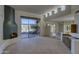 Bright living room featuring a unique fireplace, decorative display, built-in cabinets and patio access with great views at 7322 E High Point Dr, Scottsdale, AZ 85266