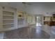 Spacious living room with built-in shelving, ceiling fan, and seamless transition to an outdoor patio at 7322 E High Point Dr, Scottsdale, AZ 85266