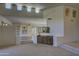 Open concept living room featuring recessed lighting, a wet bar, built-in shelving, and neutral colors at 7322 E High Point Dr, Scottsdale, AZ 85266