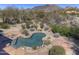 Aerial view of a backyard featuring a freeform pool with mountain views at 7322 E High Point Dr, Scottsdale, AZ 85266