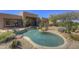 Beautiful backyard pool with desert landscaping, rock accents, and a view of the home at 7322 E High Point Dr, Scottsdale, AZ 85266