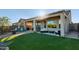 Beautiful backyard featuring an artificial lawn, covered patio, and comfortable outdoor seating at 8205 S Pioneer Ct, Gold Canyon, AZ 85118