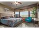 Bright bedroom featuring a bay window, turquoise chair, and decorative southwestern bedding at 8205 S Pioneer Ct, Gold Canyon, AZ 85118