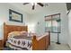 Neutral bedroom with a rustic wooden bed, quilt, and lamp at 8205 S Pioneer Ct, Gold Canyon, AZ 85118