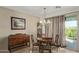 Elegant dining area with chandelier and sliding glass door at 8205 S Pioneer Ct, Gold Canyon, AZ 85118