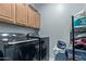 Laundry room with side by side washer and dryer and plenty of storage space at 8205 S Pioneer Ct, Gold Canyon, AZ 85118