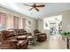 Spacious living area featuring leather reclining furniture and tile flooring at 8205 S Pioneer Ct, Gold Canyon, AZ 85118