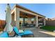 Outdoor patio featuring a chaise lounge, patio set, and artificial turf at 8205 S Pioneer Ct, Gold Canyon, AZ 85118