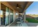 Covered patio with ceiling fan, a dining table with chairs and an outdoor lounge space at 8205 S Pioneer Ct, Gold Canyon, AZ 85118