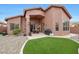 Covered patio and backyard featuring decorative rock, green artificial turf, and built in gas grill at 9706 E Sheena Dr, Scottsdale, AZ 85260