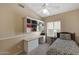 Bright bedroom features large window, ceiling fan and custom built in desk and shelving at 9706 E Sheena Dr, Scottsdale, AZ 85260