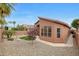 The exterior shows rock landscaping, a small patch of grass, and peach stucco at 9706 E Sheena Dr, Scottsdale, AZ 85260